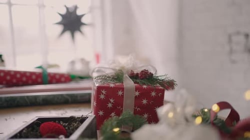 A Packaged Gift Stands on the Table and the Camera Flies Around the Table in Slow Motion