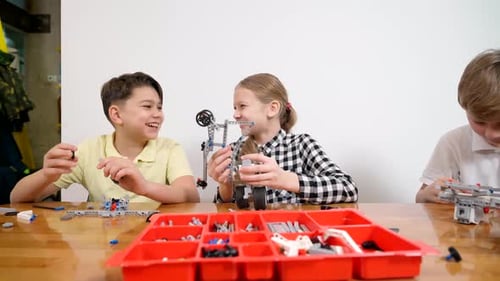 Young Friends Having Fun Using Building Kit