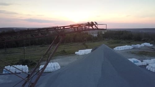 Rusty Mining Sector Equipment Under Orange Morning Sky