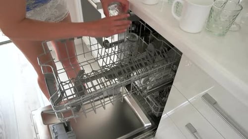 Woman Unloading Glassware from Dishwasher