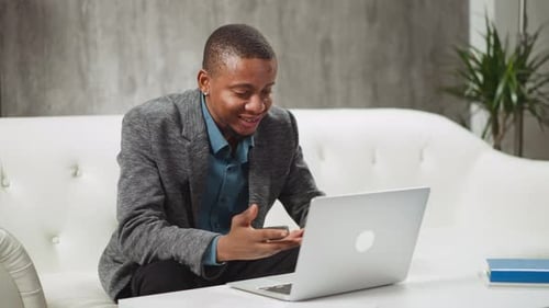 Man Talking on Laptop During a Video Conference