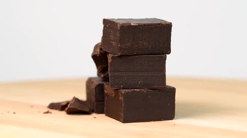 Delicious Dark Chocolate Squares Stacked on Wood