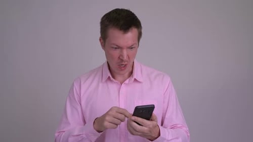 Excited Man Using Smartphone Giving Thumbs Up