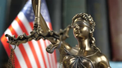 Statue of Lady Justice with Books and USA Flag