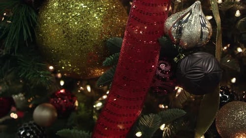 Panning view of christmas tree covered in decorations