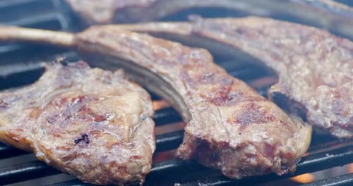 Delicious Rack of Lamb Is Fried on Fire on Grill with Smoke.