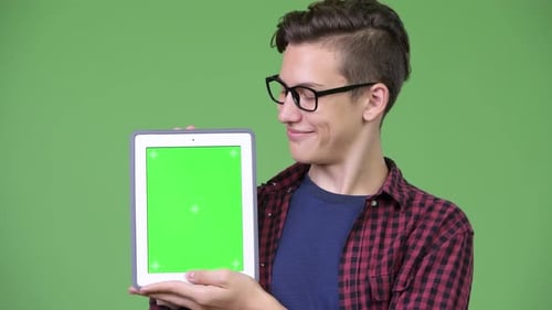 Young Man Holding Tablet with Green Screen Display