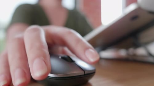 Female hands of business freelance Asian woman click mouse button