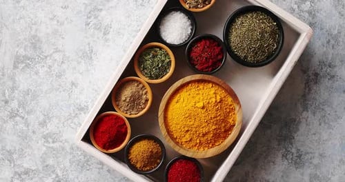 Colorful Spices and Herbs Arranged in Bowls