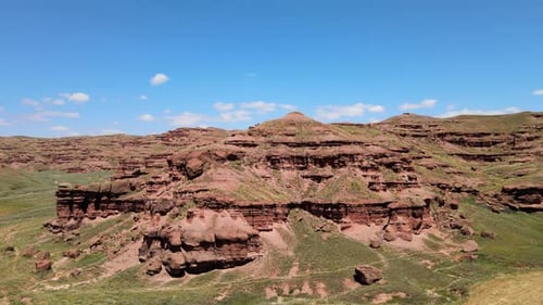 green valley and red mountains landscape