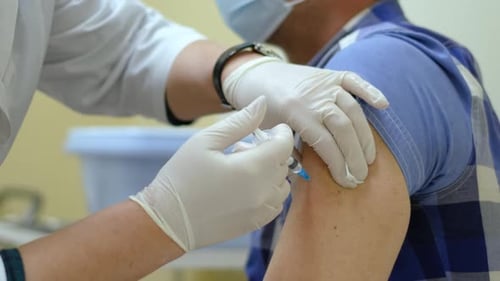 Healthcare Worker Giving Adult Injection in Arm