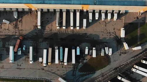 Flycam Films Big Trucks Standing in Row at Loading Gates