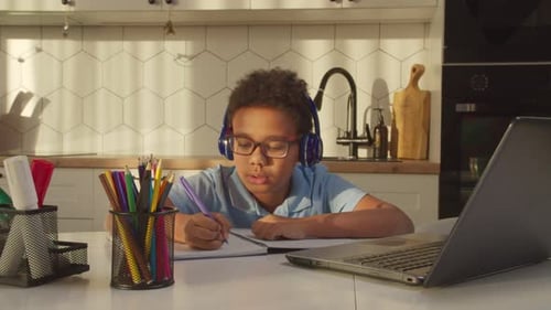 Child Engaged in Remote Learning at Home