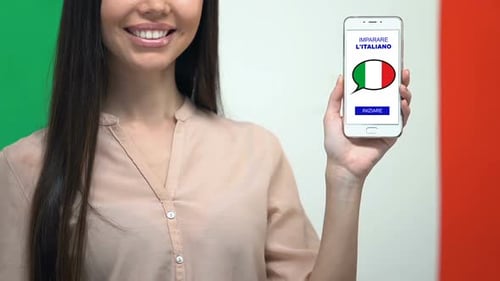 Apprendre l'application de langue italienne sur l'écran du smartphone dans la main féminine, éducation en ligne