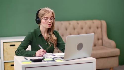 Woman Working at Laptop in Home Office
