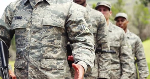 Serious Soldiers Holding Rifles Stand at Attention