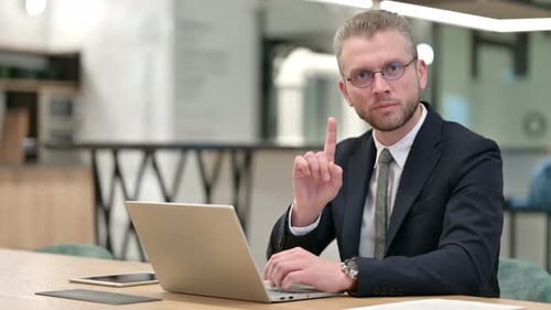 Man Working on Laptop at Office Desk