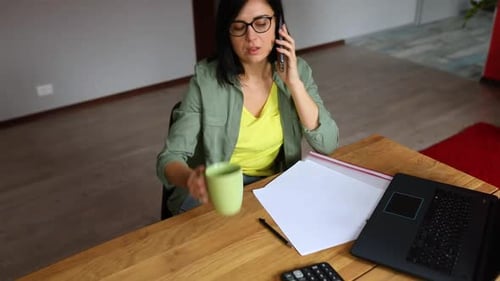 Woman Talking on Phone and Drinking Coffee