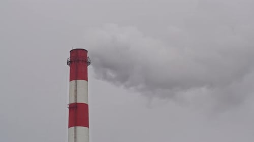Industrial Smokestack Emitting Smoke on Overcast Day