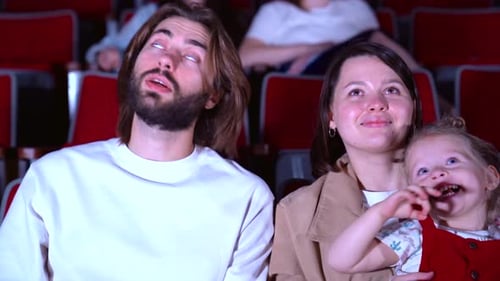 Family watching film at the cinema