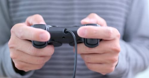 Person Playing Video Game with Controller