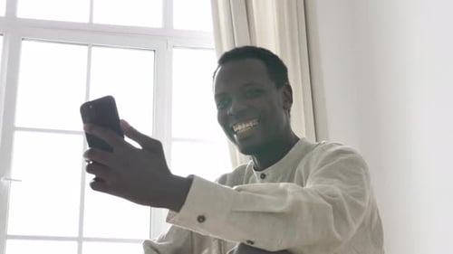 Smiling Man Video Calling on Smartphone