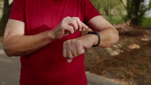 Adult Using Smartwatch on Park Path