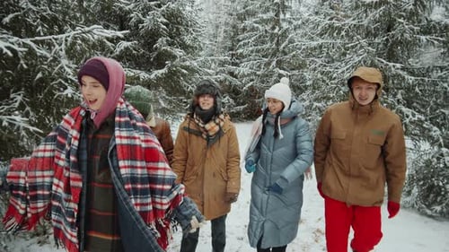 Friends Walking in Winter Forest
