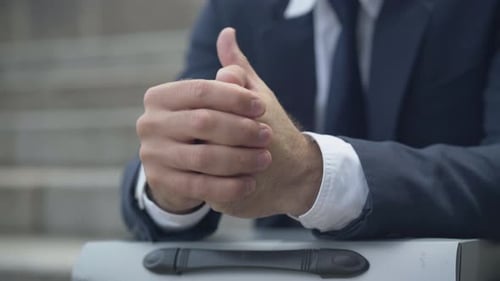 Close-up Hands of Stressed Nervous Businessman Sitting Outdoors. Palms of Unrecognizable Caucasian