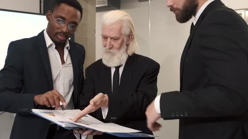 Business Colleagues Reviewing Charts in Modern Office