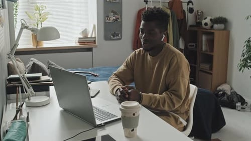 Man Attends Video Call at Desk