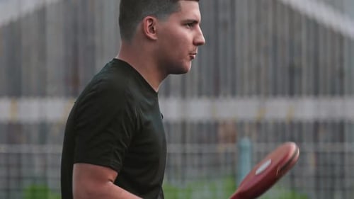 Athletic Man Practicing Martial Arts With Punching Pads