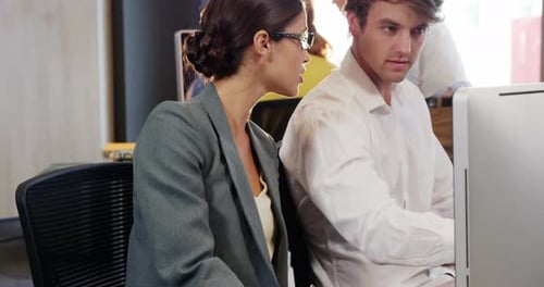 Professionals Collaborating at Computer in Modern Workplace