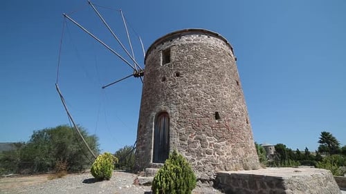 Stone Windmill Landmark Under a Blue Sky