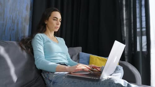 Woman Uses Laptop Computer at Home