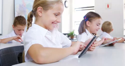 School kids using digital tablet in classroom