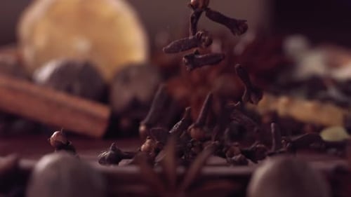 Cloves Falling onto Spices in Slow Motion