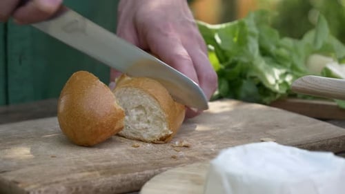 Bread Sliced on Wooden Cutting Board Outdoors
