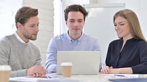 Team Working Together at Desk During Video Call