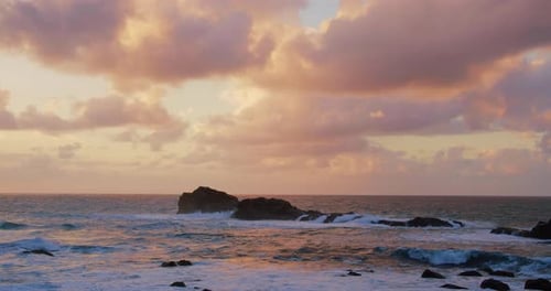 Slow Motion of Ocean Waves Crashing on Volcanic Rocky Shore