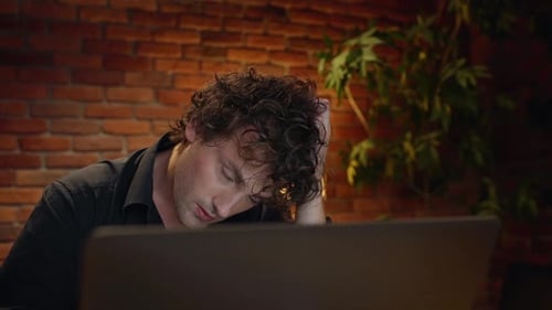 Displeased Young Successful Businessman Working in Office at Night