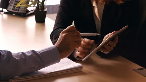 Business Meeting with Tablet and Notepad