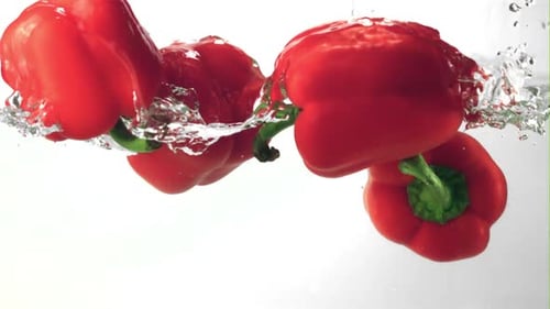 Super Slow Motion Sweet Pepper Floats in the Water with Splashes