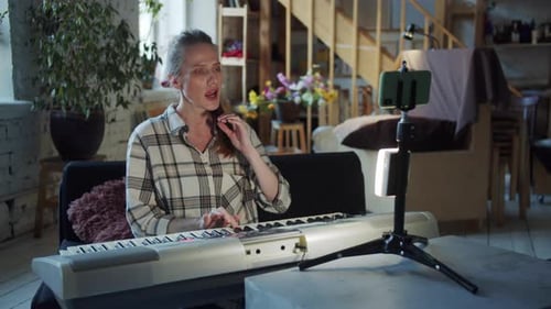 Woman Plays Piano in Her Home Studio