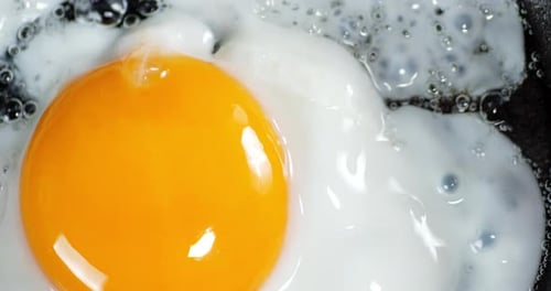 The Egg Is Fried with Hot Oil with Air Bubbles.