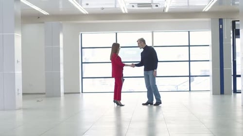 Business People Shake Hands in Modern Office Space