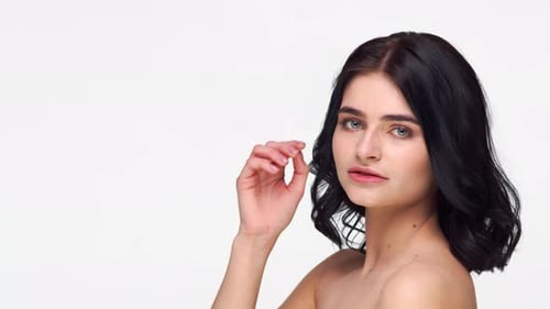 Studio portrait of young and beautiful brunette woman.