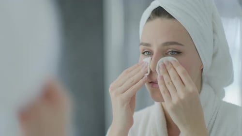 Woman Cleans Her Face with Cotton Pads