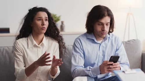 Emotional Stressed Woman Talking to Marital Counselor Annoyed Man Browsing on Smartphone Slow Motion