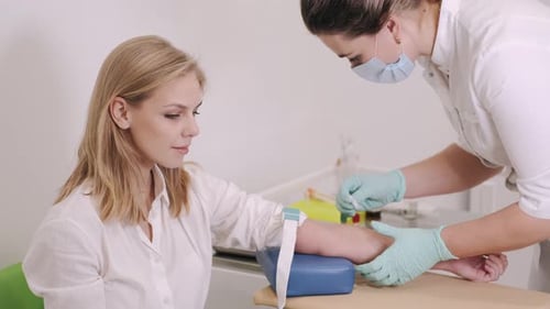 Healthcare Provider Drawing Blood from Patient in Office